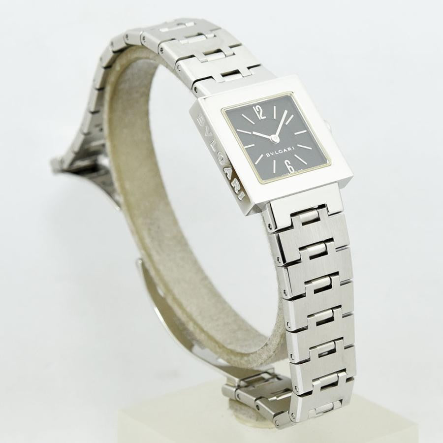 VINTAGE WATCHES FASHIONのブルガリ製スクエアフェイスレディース腕時計。シルバーカラーのステンレススチール製ケースとブレスレット、ダークグレーの文字盤。12時と6時のアラビア数字がアクセント。