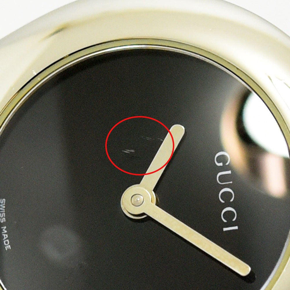 VINTAGE WATCHES FASHIONのGUCCI 6700Lレディース腕時計。ブラック文字盤にわずかな傷があるステンレススチール製バングルウォッチのクローズアップ。