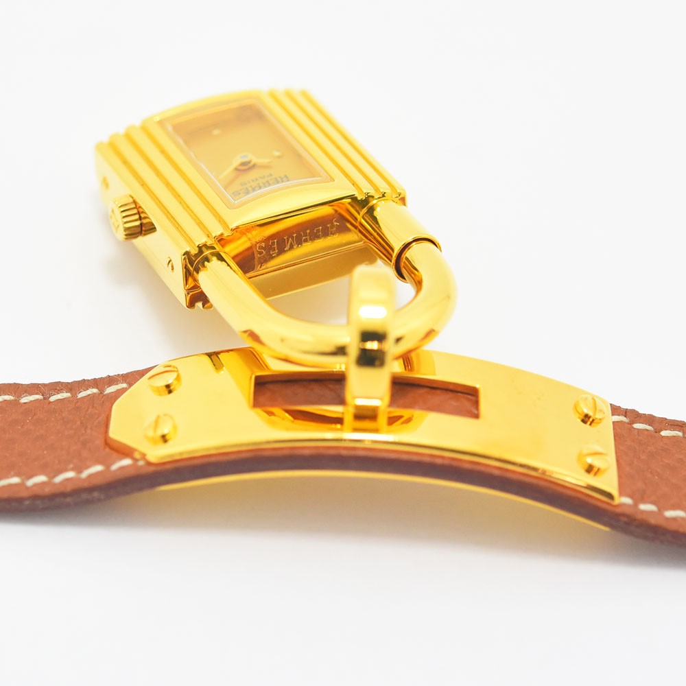 VINTAGE WATCHES FASHIONのエルメス ケリーウォッチ。ゴールドの南京錠モチーフケースとブラウンレザーベルトが特徴のレディース腕時計。